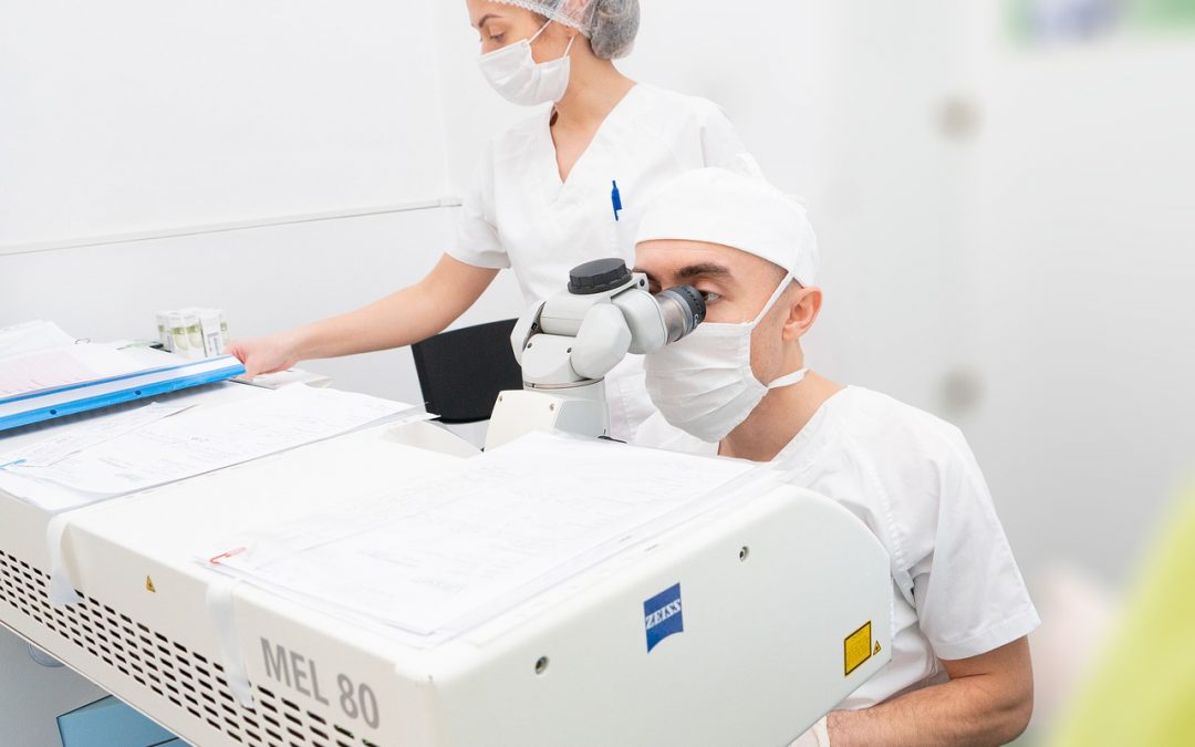 a doctor and a nurse performing Lasik surgery
